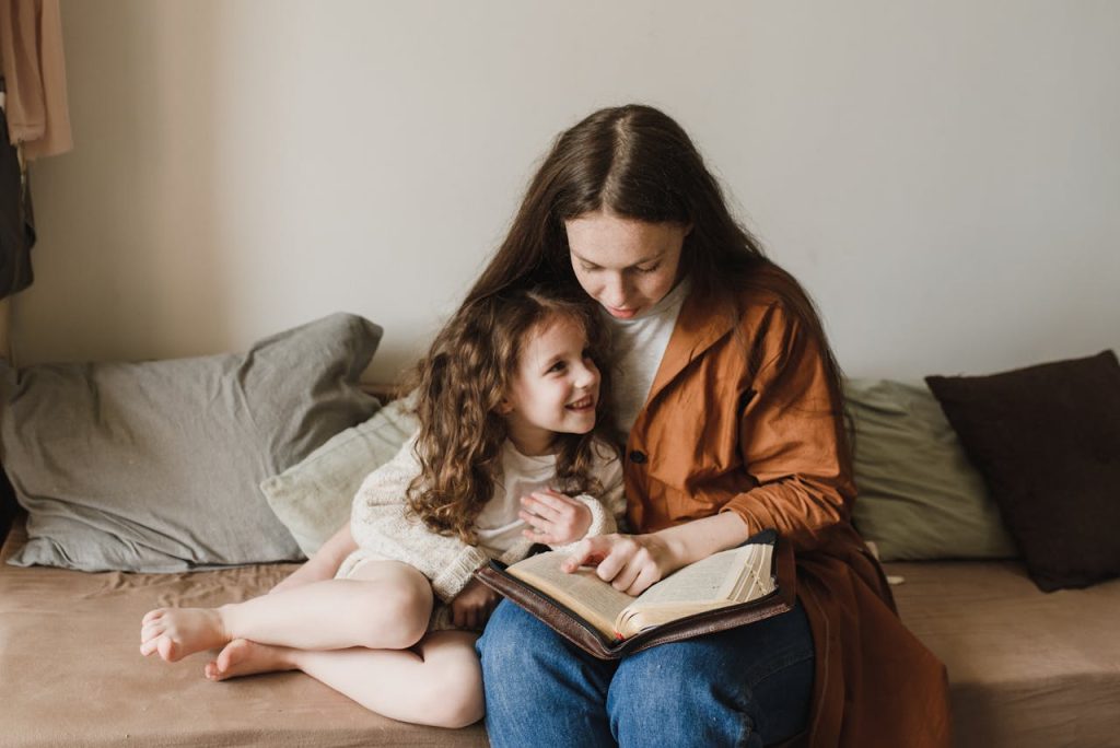 Mother and daughter enjoying a cozy reading moment at home, fostering a love for books.